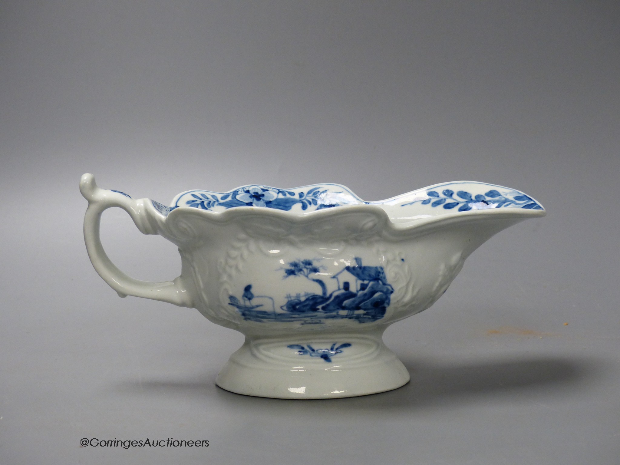 A Worcester sauceboat of high footed silver shape painted with the uncommon Triangular Platform pattern in under glaze blue, workman on underside of handle c.1755, 19cm wide including handle